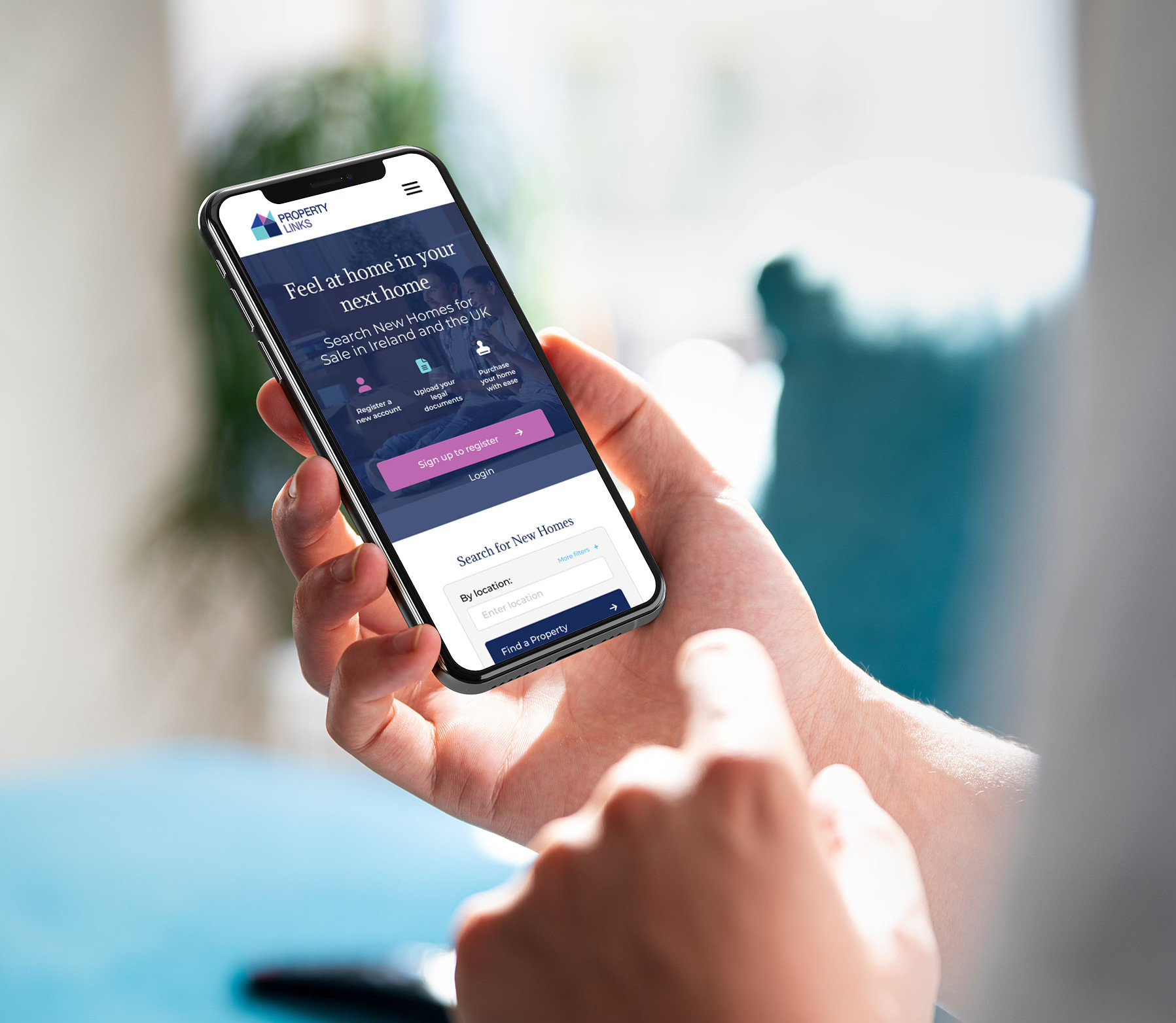 A person holding a smartphone displaying a property website.